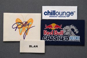 woven clothing label design examples showing size contrast and detail for apparel branding