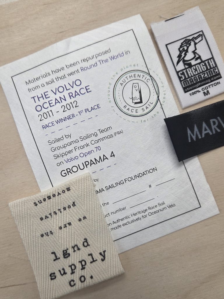 Examples of printed clothing labels on cotton, satin, Tyvek, and cotton twill materials