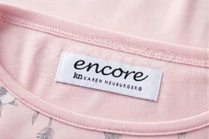 Damask woven clothing label sewn inside women’s pajamas showing fine detail and high thread count