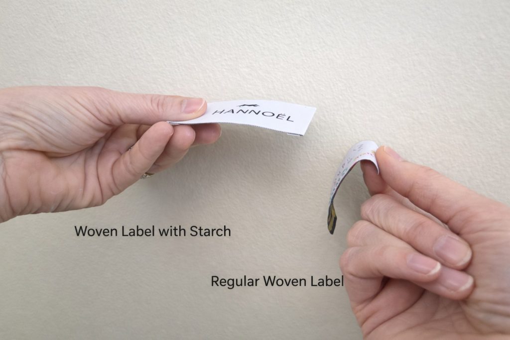 Woven label with starch compared to regular woven label showing stiffness and flexibility