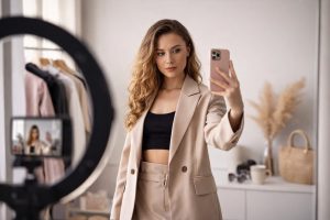 Fashion influencer creating social media content showcasing outfit and influencing clothing trends