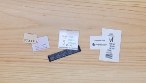 cotton, satin, and nylon printed labels shown side by side for comparison