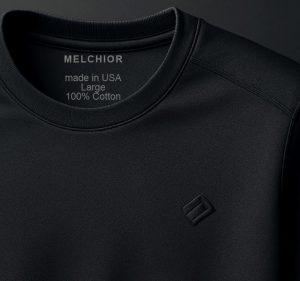 Modern black athletic shirt showing neckline and subtle embroidered logo, representing contemporary tagless apparel design.